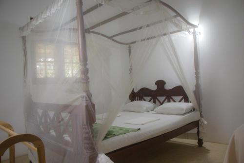 Ένα ή περισσότερα κρεβάτια σε δωμάτιο στο Jungle View Guesthouse Unawatuna
