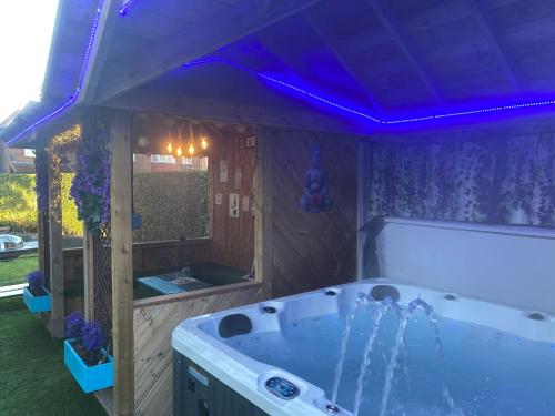 a bathroom with a tub with a purple lighting at Beautifully presented 6 bed 5 & a half bath house in Newcastle upon Tyne