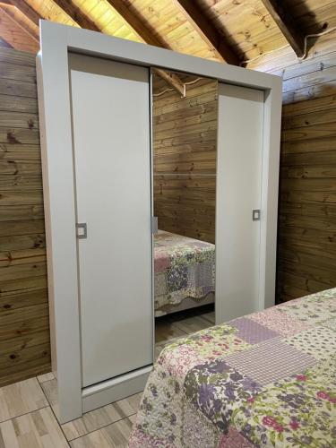 two doors in a bedroom with two beds at Cabana Bacana in Praia Grande