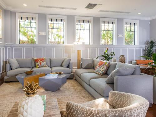 a living room with couches and tables and windows at Marlin Bay Resort & Marina Managed by Elite Alliance Hospitality in Marathon