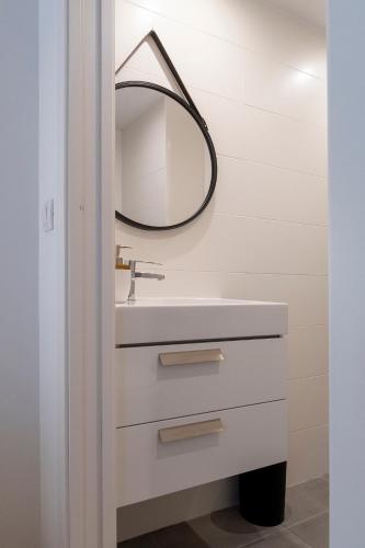 a bathroom with a sink and a mirror at Moontels Paseo de Ruzafa in Valencia