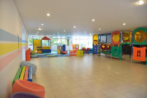a large room with a play room with a playground at Hotel Majestic in Águas de Lindóia