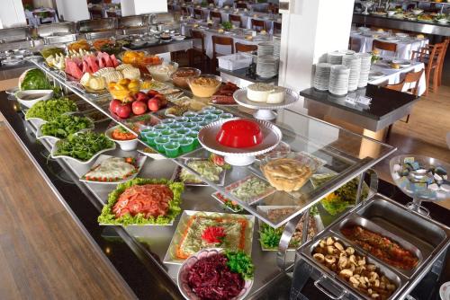 a buffet line with many different types of food at Hotel Majestic in Águas de Lindóia