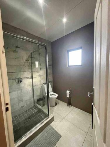 a bathroom with a shower and a toilet at 7th Heaven in Tugela Mouth