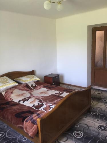 a bedroom with a large bed with a cow blanket at Friend's House rooms near Airport in Yerevan