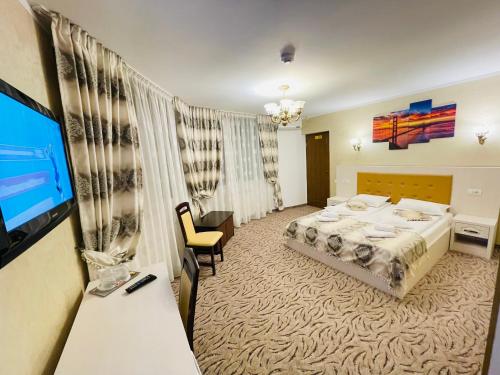 Кровать или кровати в номере Pensiunea Ianis Piatra Neamt