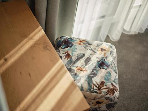 a chair with a floral seat in a room at Sun Lodge in Ischgl
