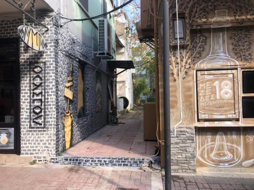 an alley with a sign on the side of a building at Stamatina’s Luxury Apartments (central) in Alexandroupoli