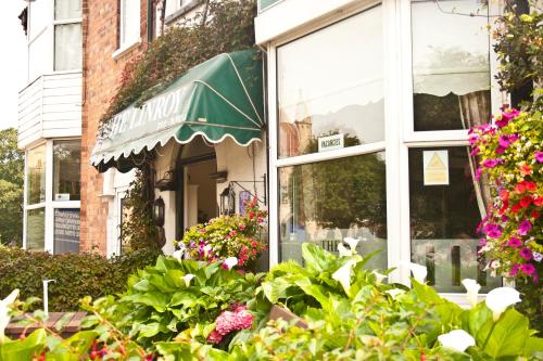 a window of a store with flowers and plants at Linroy Guest House in Skegness