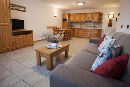 a living room with a couch and a table at lareit appartamenti in Bormio