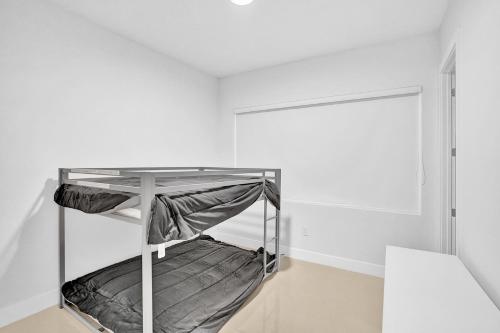 a white room with a bunk bed in it at Mimosa Sunrise Villa in Pompano Beach