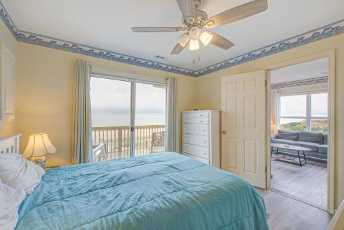 a bedroom with a bed and a ceiling fan at 1 Anchors Away Oceanfront in Holden Beach