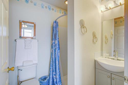 a bathroom with a toilet and a sink at 1 Anchors Away Oceanfront in Holden Beach