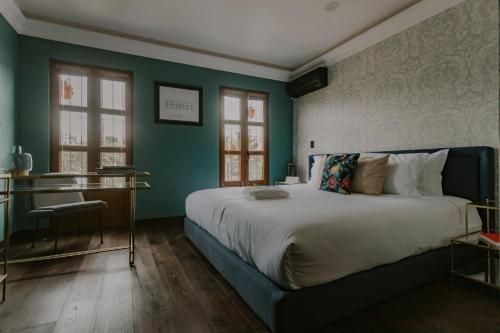 ein Schlafzimmer mit einem großen Bett und grünen Wänden in der Unterkunft Matiana Estudiante in Zacatecas