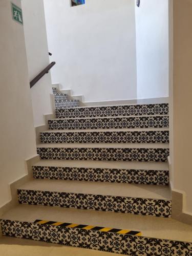 a staircase with a black and white patterned carpet at Marboka Hotel & Suites in Puerto Vallarta