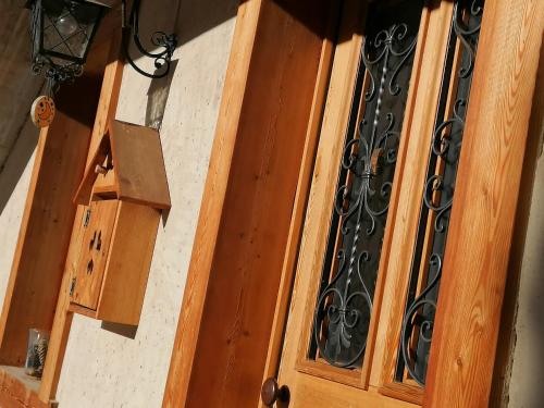 an open wooden door with a wrought iron gate at L'inizio... in Val di Zoldo