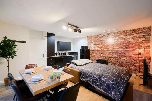 a bedroom with a bed and a table with chairs at LocationsTourcoing - Le Corneille in Tourcoing
