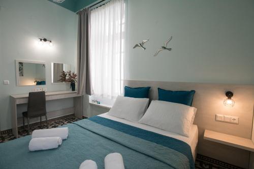 a bedroom with a large bed with a blue blanket at The Blue apartment in the heart of Heraklion in Heraklio Town
