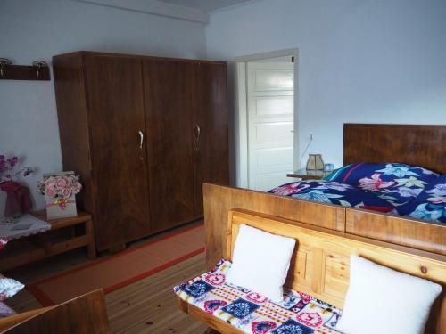a bedroom with a bed and wooden cabinets and a table at B&B Signora Elvira in Capriana