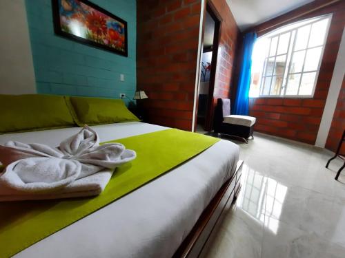a bedroom with a bed and a window at Hostal Balcon del Cielo in Baños