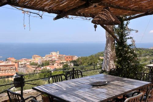 a wooden table with a view of a city at Villa San Francesco in Massa Lubrense