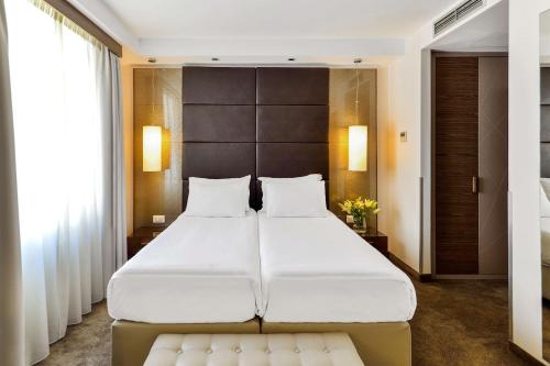 A bed or beds in a room at Belgrade Art Hotel, a member of Radisson Individuals