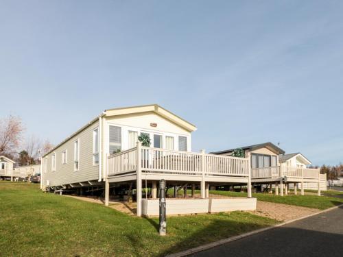 a large manufactured home with a large deck at 23 Valley View in Morpeth