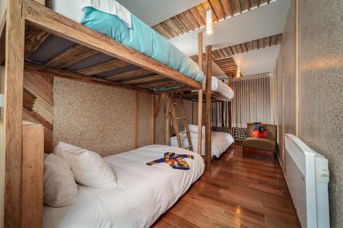 a bedroom with two bunk beds and a chair at Mamallacta Páramo Lodge in Papallacta