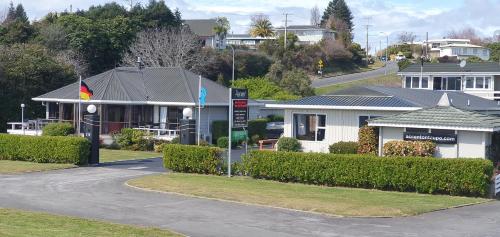 a house with a flag in front of a street at Accent On Taupo Motor Lodge in Taupo