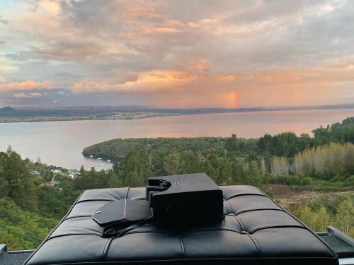 a view of a lake with a laptop on top at Acacia Cliffs Lodge in Taupo