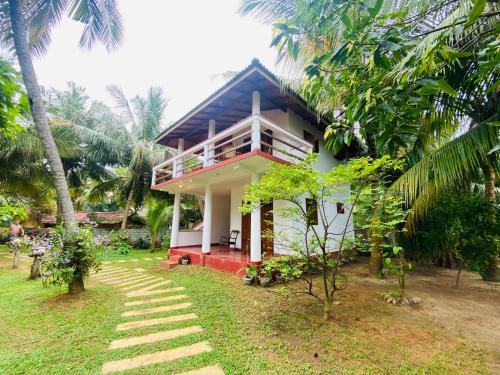 a house with a staircase leading up to it at Hidden Garden Tangalle in Tangalle