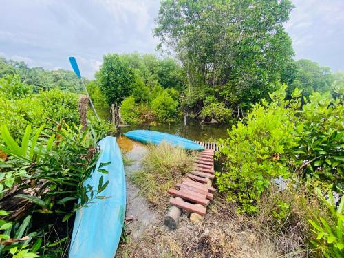 a couple of boats are sitting in the water at Hidden Garden Tangalle in Tangalle