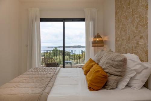 a bedroom with a bed with a view of the ocean at Casa Marina Cargèse in Cargèse