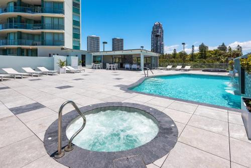 a hot tub on a patio next to a building at The Waterford on Main Beach in Gold Coast