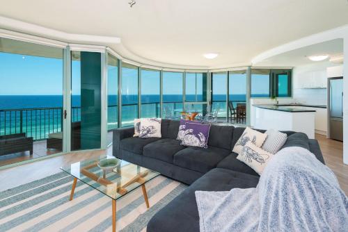 a living room with a couch and a view of the ocean at The Waterford on Main Beach in Gold Coast