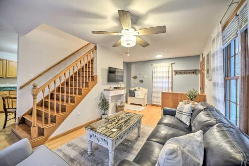 a living room with a couch and a ceiling fan at Lake Luzerne Home with Fire Pit on Hudson River in Lake Luzerne