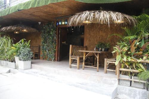 a patio with a table and chairs and plants at Samui Beach Residence Hotel in Chaweng