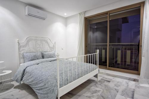 a bedroom with a bed and a large window at Lovely studio 5 min from Casablanca airport in Nouaseur