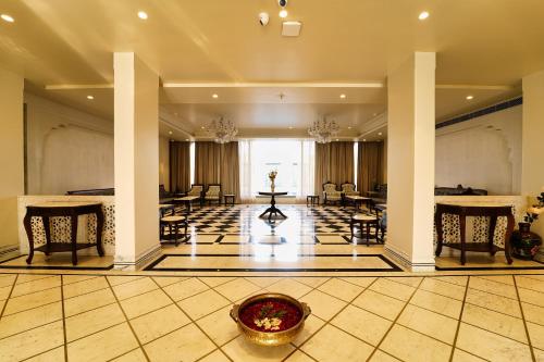 a lobby with chairs and a table in a building at Sahdev Bagh in Pushkar