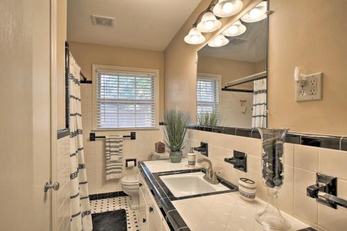 a bathroom with a sink and a toilet and a mirror at Charming Florence Getaway with Fireplace and Grill! in Florence
