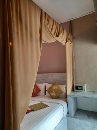 a bedroom with a bed with a canopy at Samui Beach Residence Hotel in Chaweng