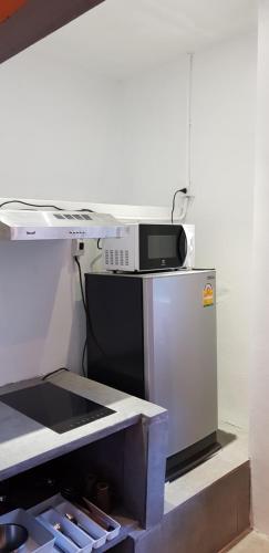 a microwave oven sitting on top of a refrigerator at Samui Beach Residence Hotel in Chaweng