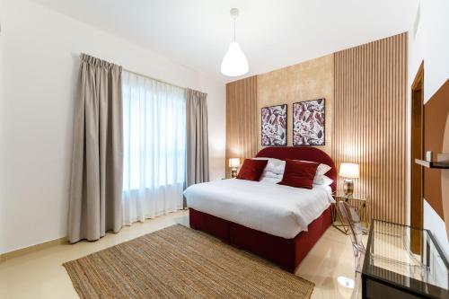 a bedroom with a bed and a large window at FAM Living - Al Safa Residences - SZR in Dubai
