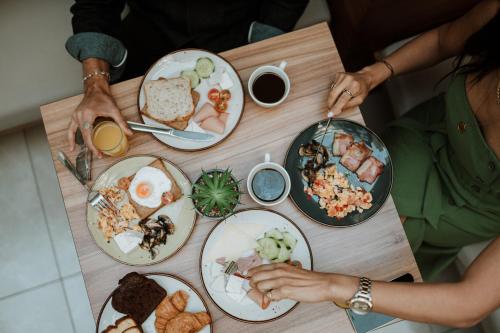 a group of people sitting at a table with plates of food at Infinity City Boutique Hotel in Heraklio Town