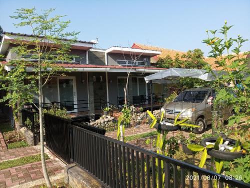 a van parked in front of a house at Pondok Wammy Syariah in Cigasong