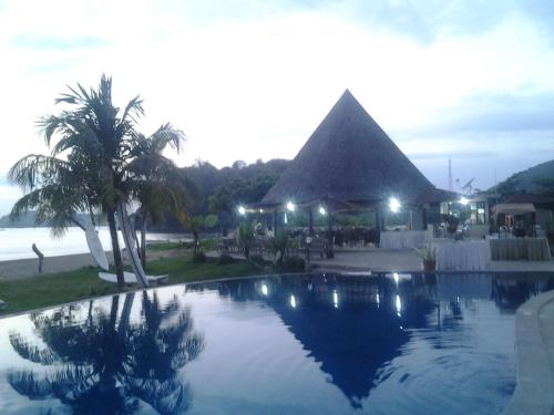a resort with a swimming pool with a pyramid at Luwansa Beach Hotel in Labuan Bajo
