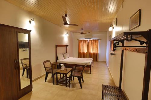 um quarto com uma mesa e cadeiras e uma sala de jantar em Hotel Orfil em Calangute