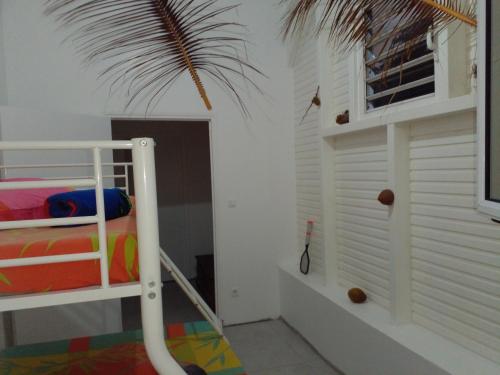 a bedroom with a bunk bed and a window at Chambre chez l'habitant avec piscine privative et vue panoramique sur la mer des caraïbes in Desmarinières