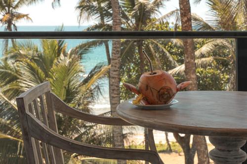 a vase sitting on top of a table at Naomi Beach Resort - Adults only in Weligama