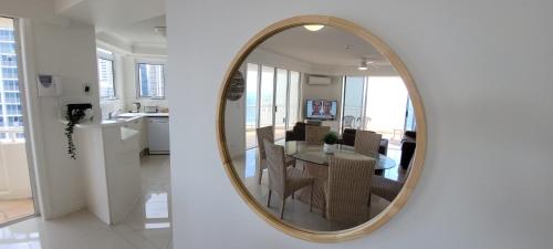 a kitchen and a dining room with a mirror at APR Private SUITES MOROCCAN by the Beach in Gold Coast